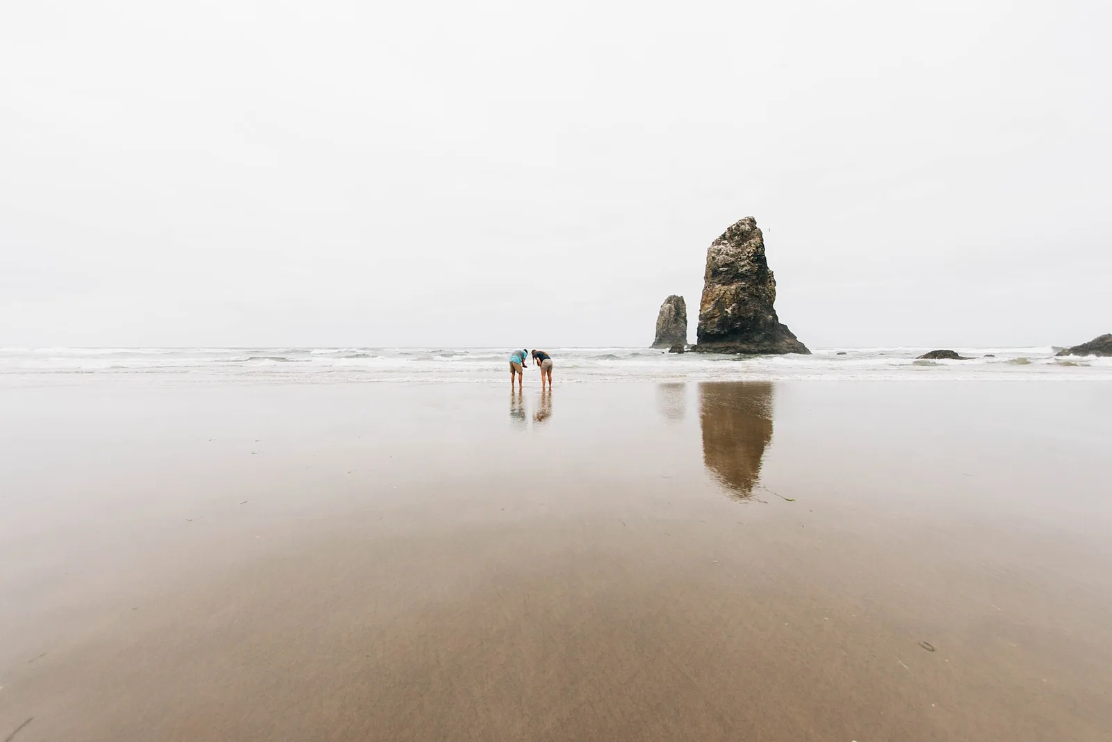 Two travelers standing on a beach